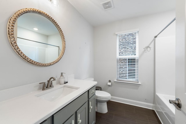 full bathroom with hardwood / wood-style floors, vanity, toilet, and shower / washtub combination