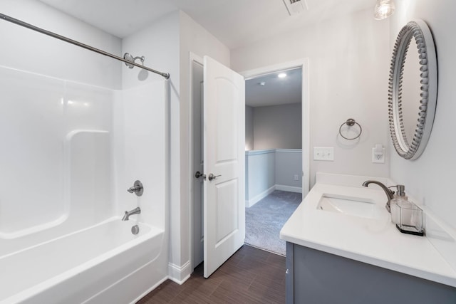 bathroom featuring vanity, hardwood / wood-style flooring, and shower / bathtub combination