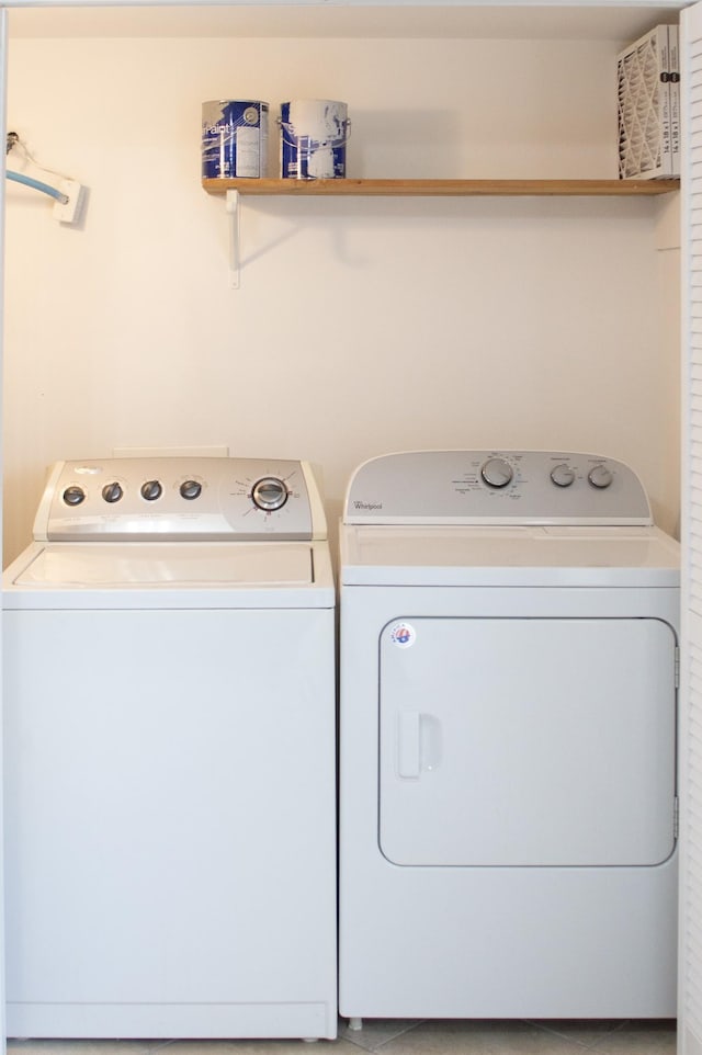 clothes washing area with washing machine and dryer