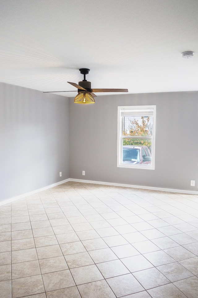 tiled empty room with ceiling fan