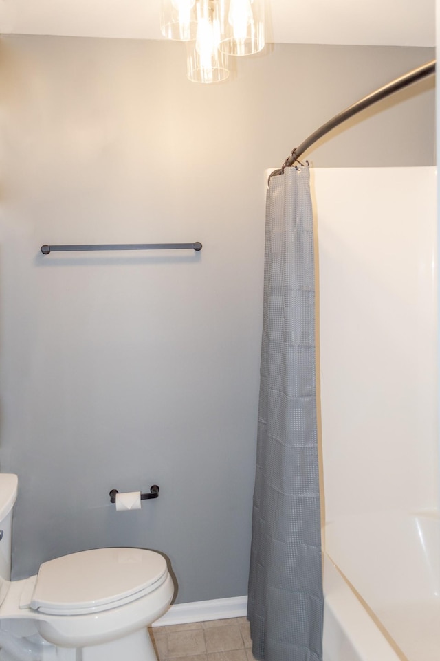 bathroom with tile patterned floors, a shower with curtain, and toilet