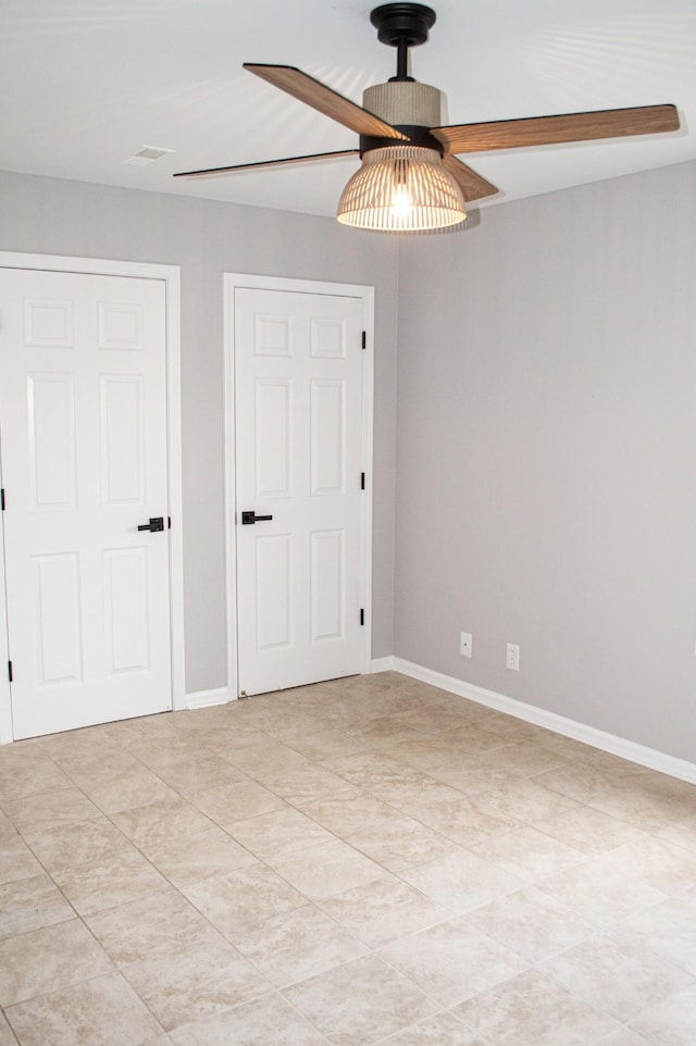 interior space featuring light tile patterned floors and ceiling fan