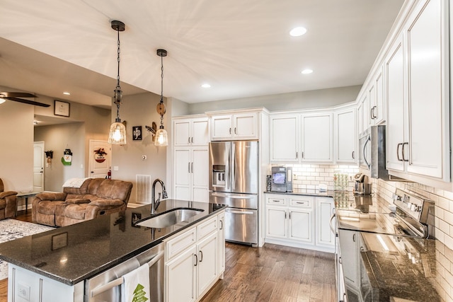 kitchen with white cabinetry, an island with sink, stainless steel appliances, and sink