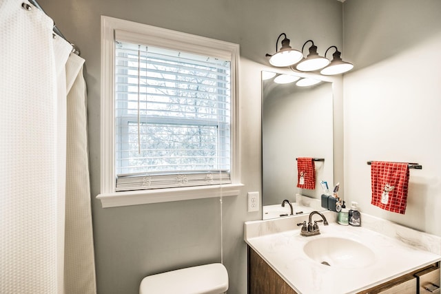 bathroom featuring vanity and toilet