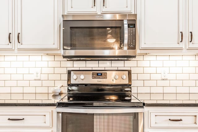 kitchen featuring stainless steel appliances, white cabinetry, and decorative backsplash