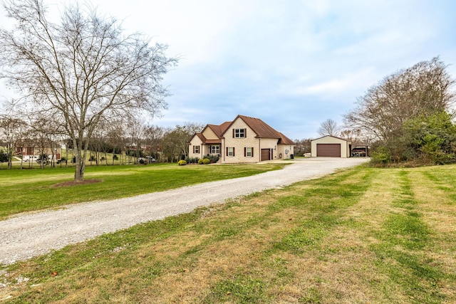 view of front of home with a garage and a front lawn