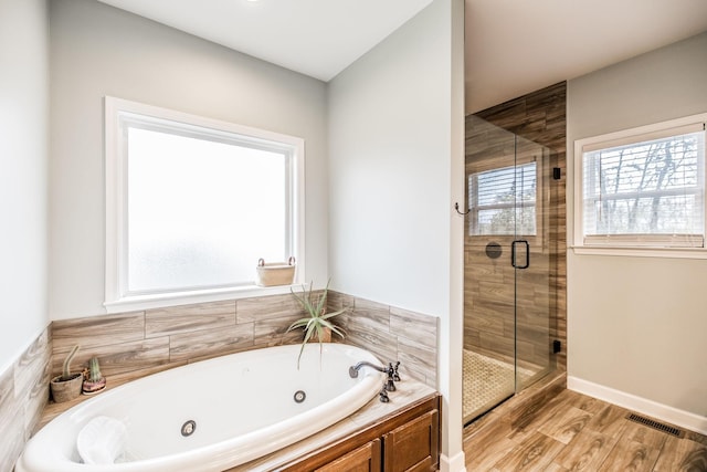 bathroom with separate shower and tub and hardwood / wood-style floors