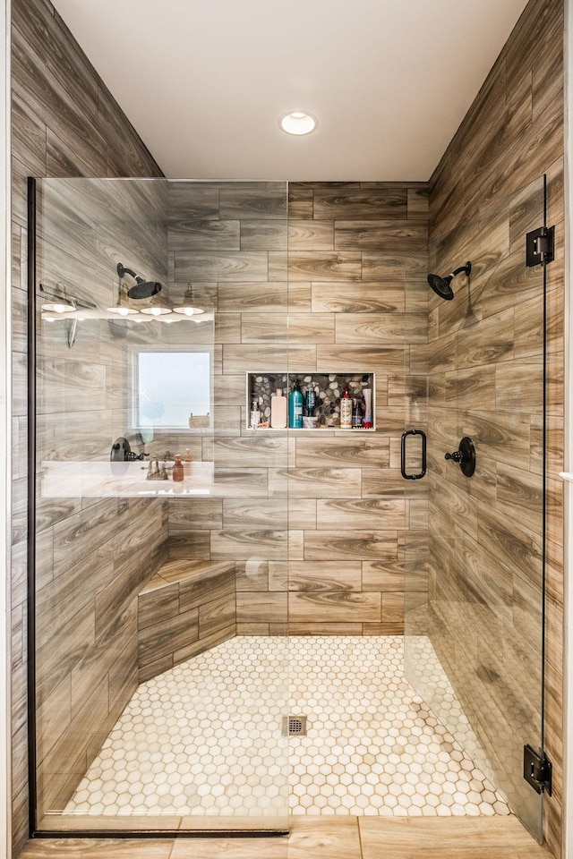 bathroom featuring a shower with shower door