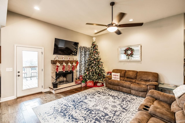 living room featuring hardwood / wood-style floors and ceiling fan