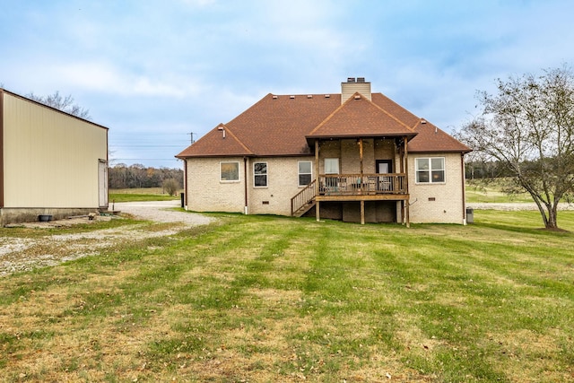 back of house featuring a wooden deck and a lawn