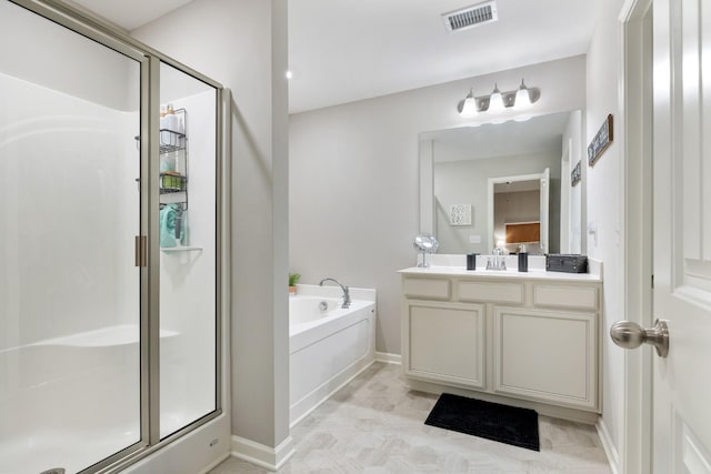 bathroom featuring vanity and independent shower and bath