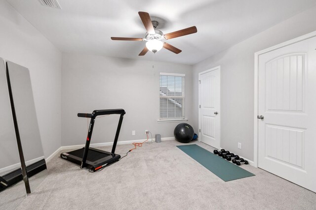 exercise area featuring ceiling fan and light colored carpet