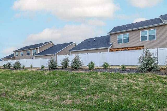 back of house featuring a yard