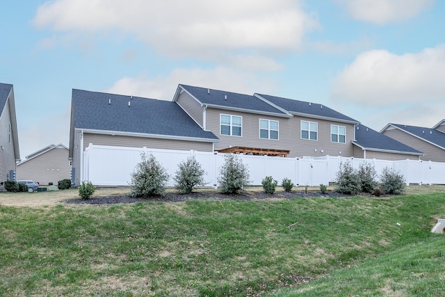 rear view of property with a yard