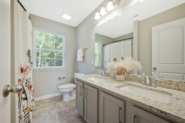 bathroom featuring tile patterned floors, vanity, and toilet