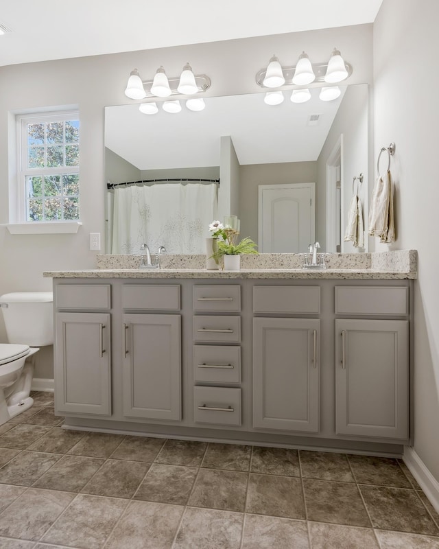 bathroom with vanity, toilet, and walk in shower