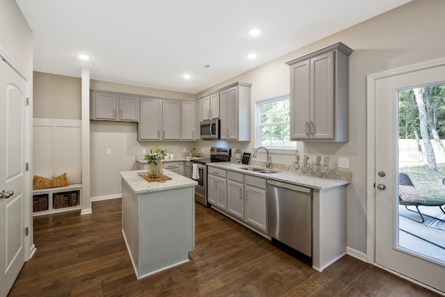 kitchen with a center island, gray cabinets, sink, and stainless steel appliances