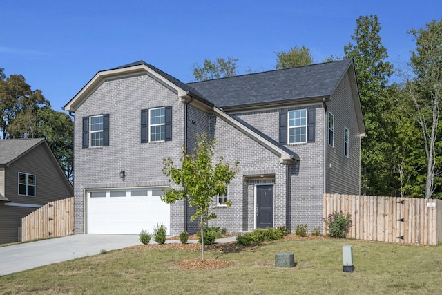 front of property featuring a front lawn and a garage