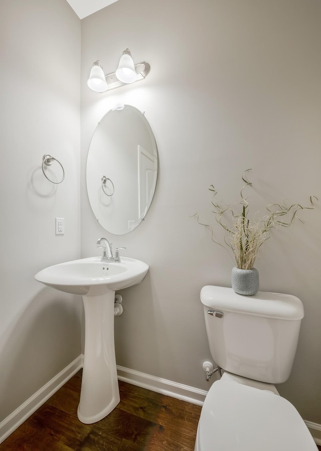 bathroom featuring toilet and wood-type flooring