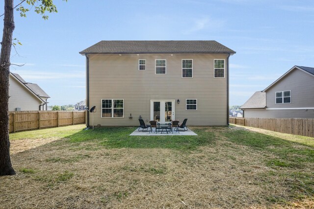 rear view of property featuring a yard and a patio