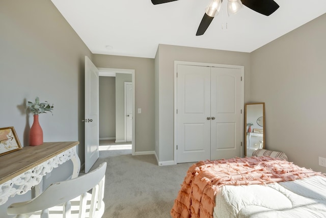 carpeted bedroom featuring ceiling fan and a closet