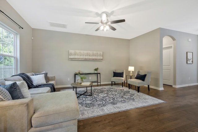 living room with dark hardwood / wood-style floors and ceiling fan