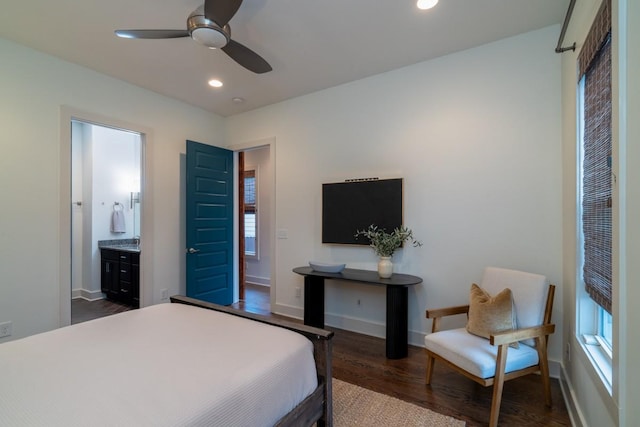 bedroom with ceiling fan, dark hardwood / wood-style flooring, and ensuite bath