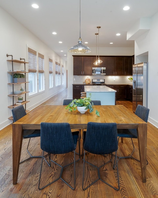 dining space with light hardwood / wood-style flooring