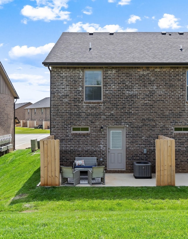 back of house with a lawn, a patio area, an outdoor hangout area, and central AC