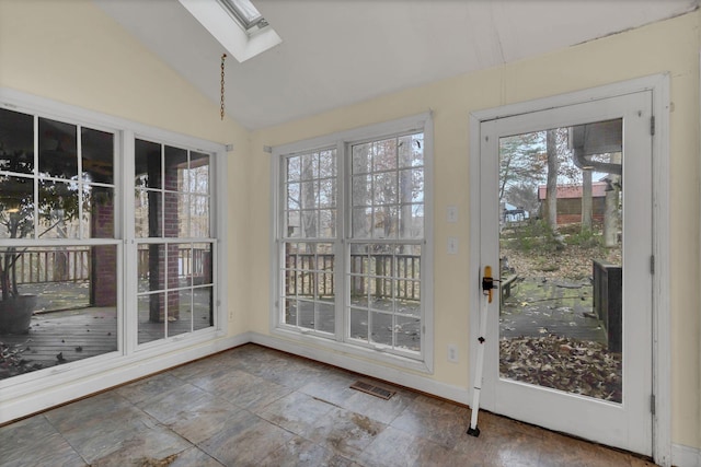 entryway with lofted ceiling with skylight and a healthy amount of sunlight