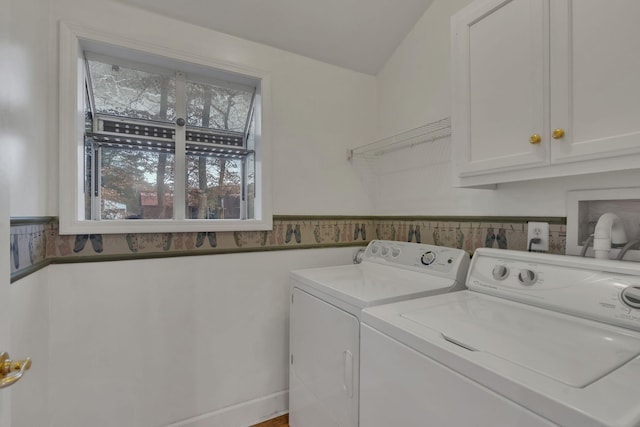 laundry area with washer and dryer and cabinets