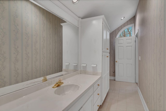 bathroom with vanity, vaulted ceiling, and tile patterned floors