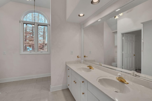 bathroom featuring tile patterned floors, vanity, vaulted ceiling, and toilet