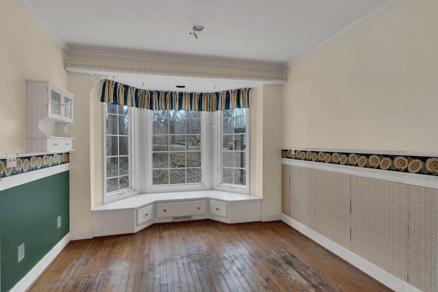 spare room with ornamental molding and dark wood-type flooring