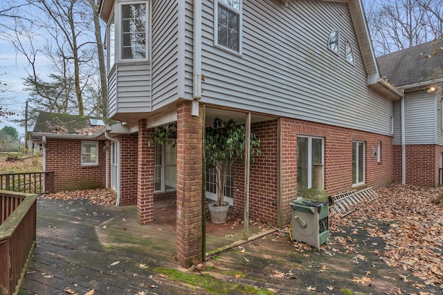 view of side of home featuring a wooden deck