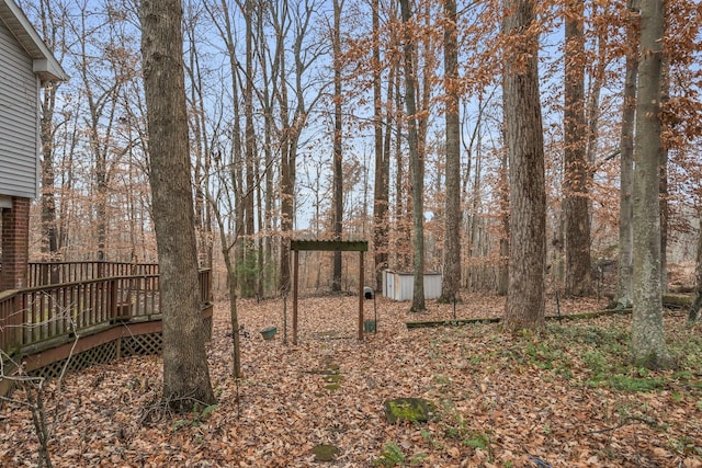 view of yard with a storage unit and a wooden deck