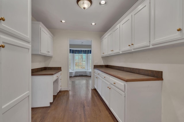 kitchen featuring white cabinetry and dark wood-type flooring