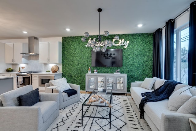 living room featuring a notable chandelier and light wood-type flooring