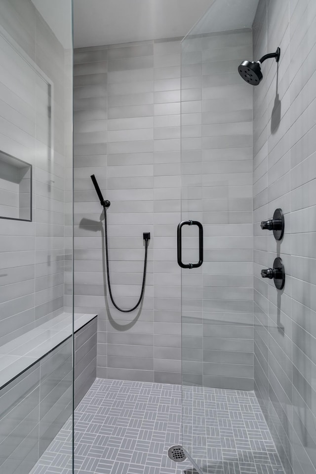 bathroom with a shower with door