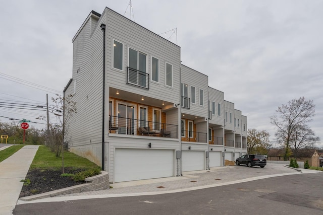 contemporary house featuring a balcony and a garage