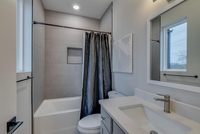 full bathroom featuring shower / bathtub combination with curtain, vanity, a healthy amount of sunlight, and toilet