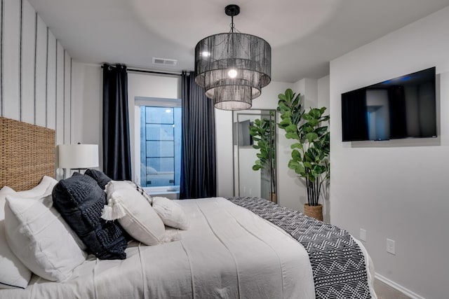 bedroom with a notable chandelier