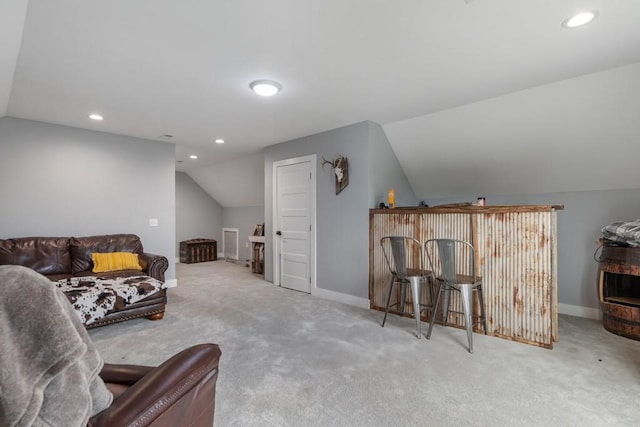 carpeted living room featuring lofted ceiling