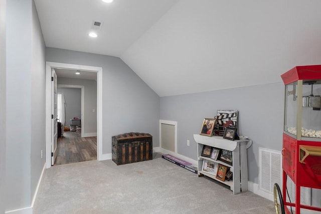 bonus room with carpet floors and vaulted ceiling