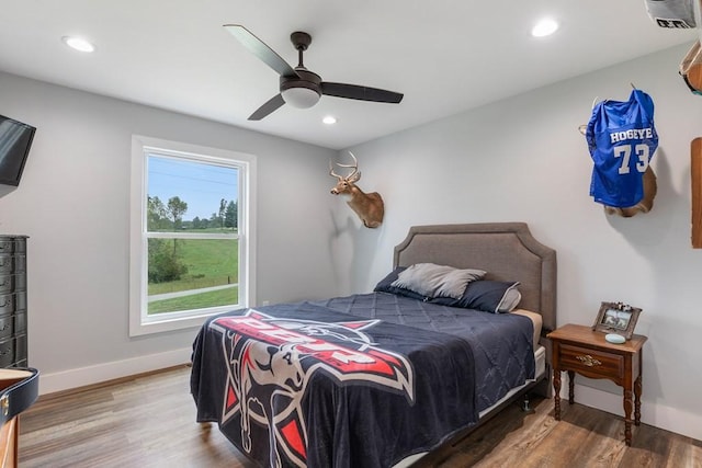 bedroom with ceiling fan and hardwood / wood-style floors