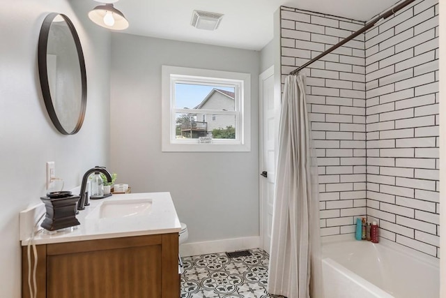 full bathroom with tile patterned flooring, vanity, toilet, and shower / bath combo with shower curtain