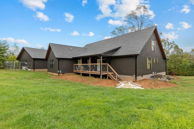 back of property featuring a lawn, a wooden deck, and central air condition unit