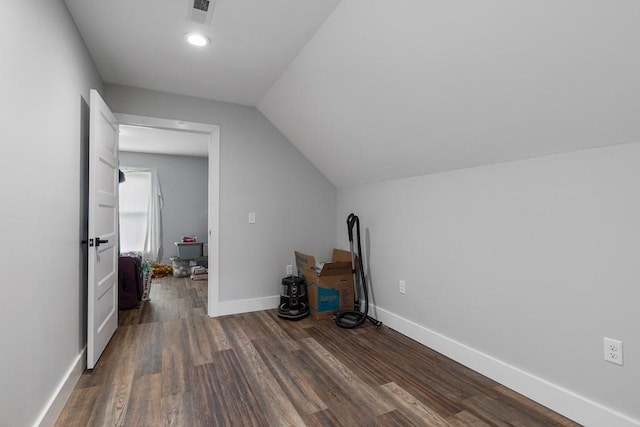 additional living space featuring dark hardwood / wood-style floors and lofted ceiling