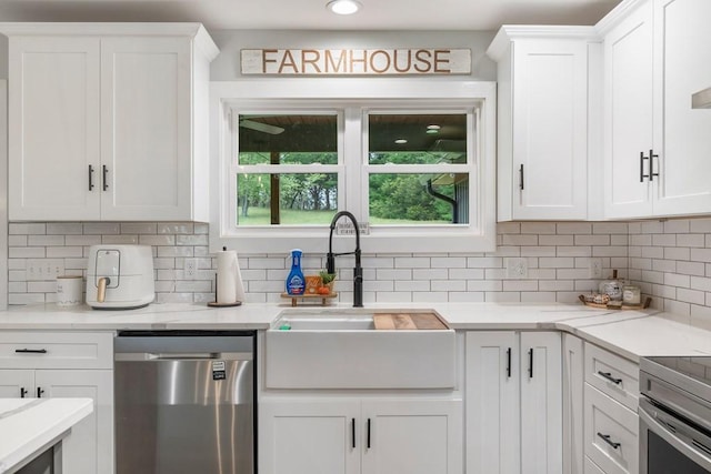 kitchen featuring white cabinetry, sink, appliances with stainless steel finishes, and tasteful backsplash