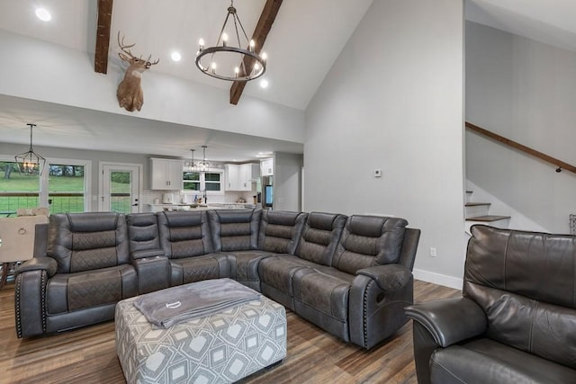 living room featuring beam ceiling, high vaulted ceiling, dark wood-type flooring, and an inviting chandelier